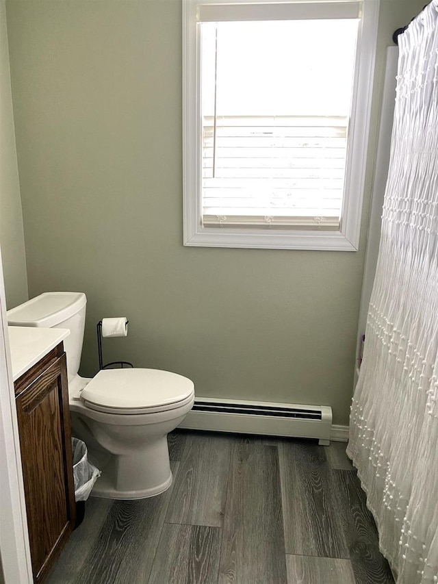 816 Gladstone St, Marinette, WI 54143 - full bath with a baseboard radiator, plenty of natural light, toilet, and vanity