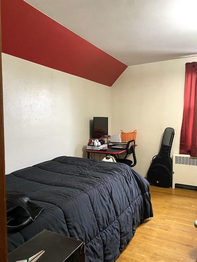 816 Gladstone St, Marinette, WI 54143 - bedroom with radiator, wood finished floors, and lofted ceiling