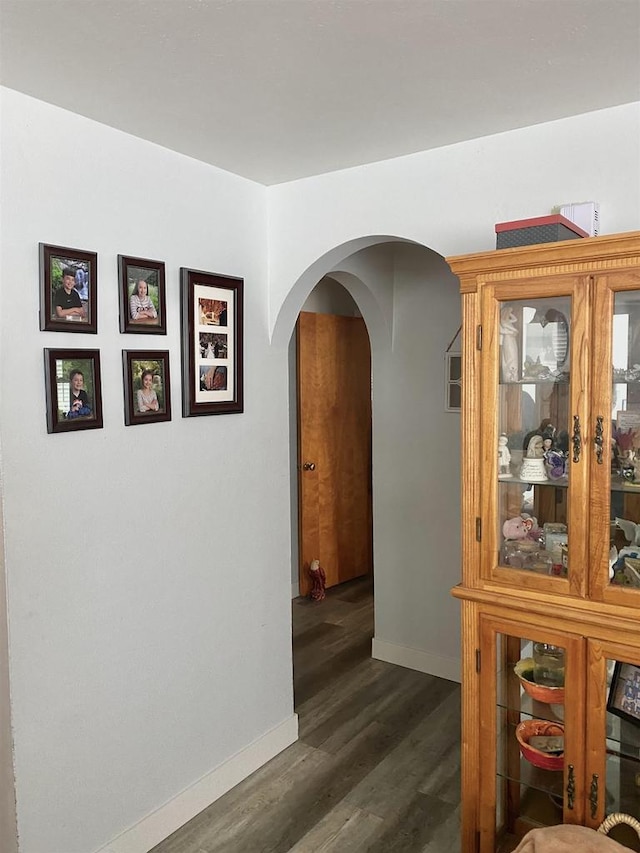 816 Gladstone St, Marinette, WI 54143 - hallway with arched walkways, wood finished floors, and baseboards