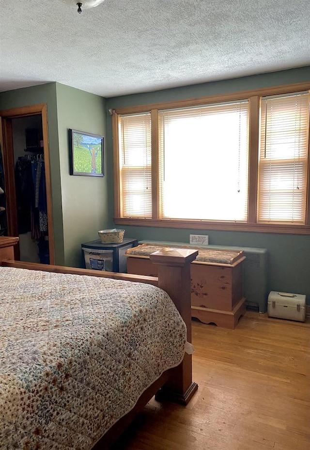 816 Gladstone St, Marinette, WI 54143 - bedroom with light wood finished floors, a closet, a textured ceiling, and a spacious closet