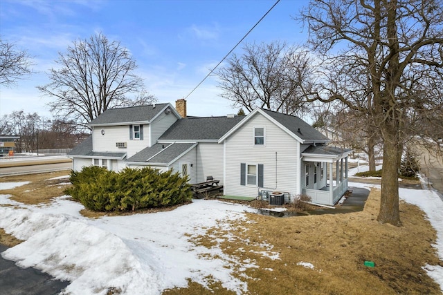 1530 Utah St, Watertown, WI 53094 - snow covered property featuring roof with shingles, central AC, a chimney, and a sunroom