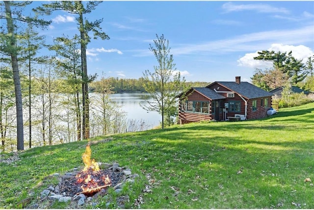 1949 E Little Blake Lake Ln, Luck, WI 54853 - view of grassy yard featuring a fire pit and a water view