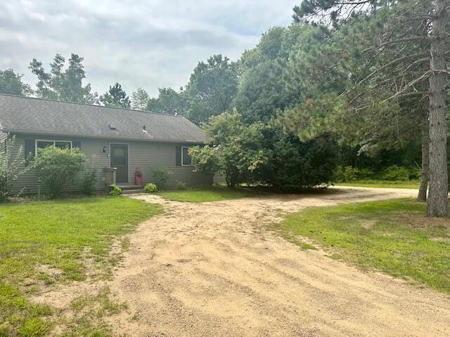 W5549 Buckhorn Dr, New Lisbon, WI 53950 - back of property featuring dirt driveway and a lawn