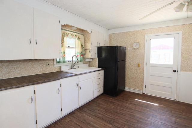 W1796 Puddlefort St, Mount Calvary, WI 53057 - kitchen with freestanding refrigerator, a sink, white cabinets, dark wood finished floors, and tasteful backsplash