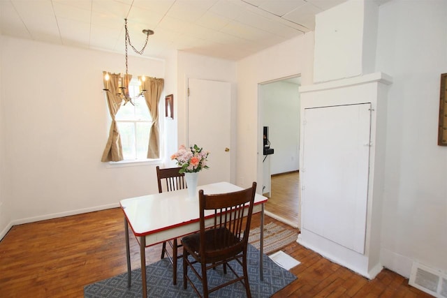 W1796 Puddlefort St, Mount Calvary, WI 53057 - dining space with a chandelier, wood finished floors, and baseboards