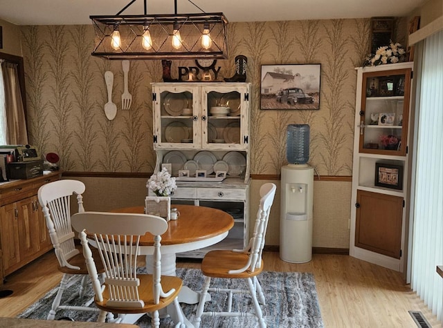 400 Old Indian Trl, Deforest, WI 53532 - dining space with wallpapered walls, a wainscoted wall, and light wood-type flooring