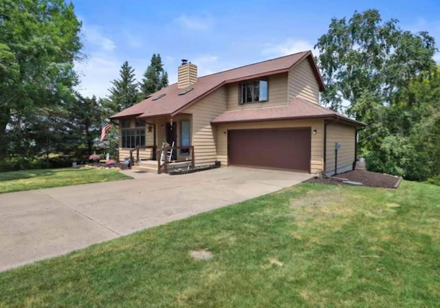400 Old Indian Trl, Deforest, WI 53532 - view of front of home with a chimney, concrete driveway, a front lawn, and an attached garage