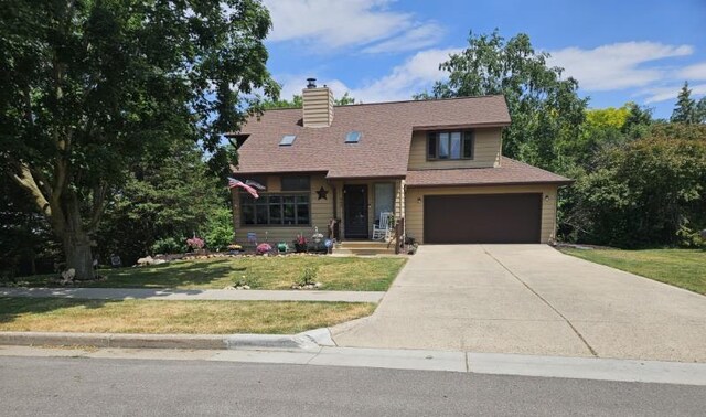 400 Old Indian Trl, Deforest, WI 53532 - view of front of property featuring a garage, a front lawn, concrete driveway, and a chimney