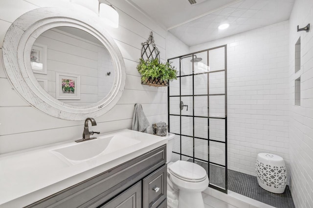 18 Abbey Villas Cir Unit G, Fontana, WI 53125 - bathroom featuring toilet, tile walls, vanity, a stall shower, and recessed lighting
