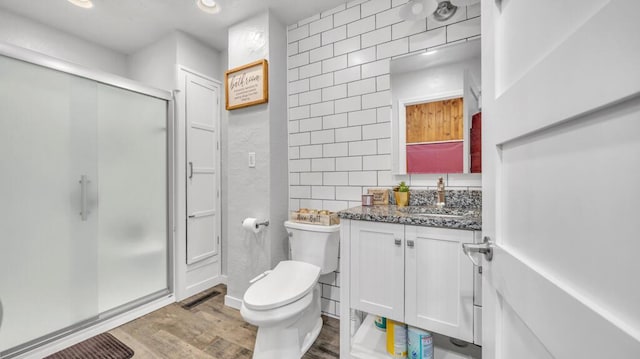 N2289 US Highway 45, Campbellsport, WI 53010 - bathroom featuring a shower stall, vanity, toilet, wood finished floors, and tile walls