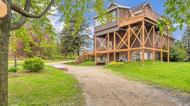 N2289 US Highway 45, Campbellsport, WI 53010 - view of front facade featuring a wooden deck, a front lawn, stairs, and stone siding