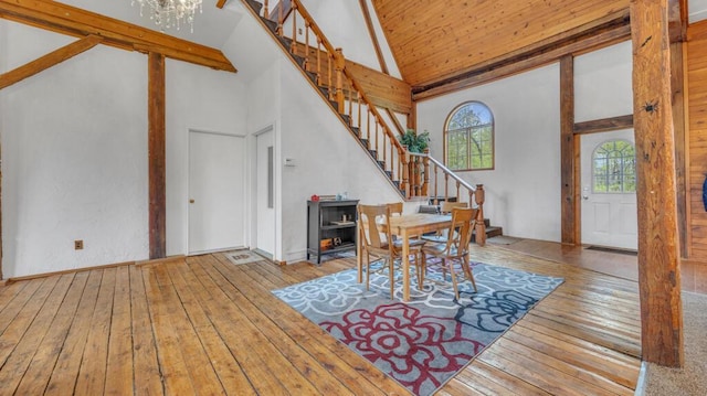 N2289 US Highway 45, Campbellsport, WI 53010 - dining space with stairs, hardwood / wood-style floors, high vaulted ceiling, and a chandelier