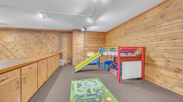 N2289 US Highway 45, Campbellsport, WI 53010 - unfurnished bedroom with track lighting, carpet flooring, and wood walls