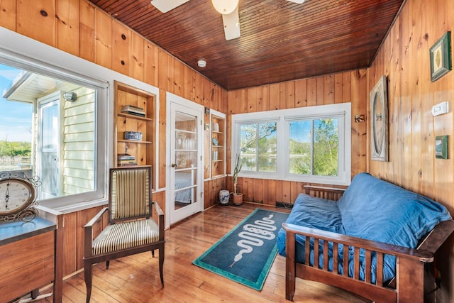 W6641 N Lakeshore Dr, Elkhorn, WI 53121 - sitting room with wood walls, hardwood / wood-style flooring, a ceiling fan, built in features, and wooden ceiling