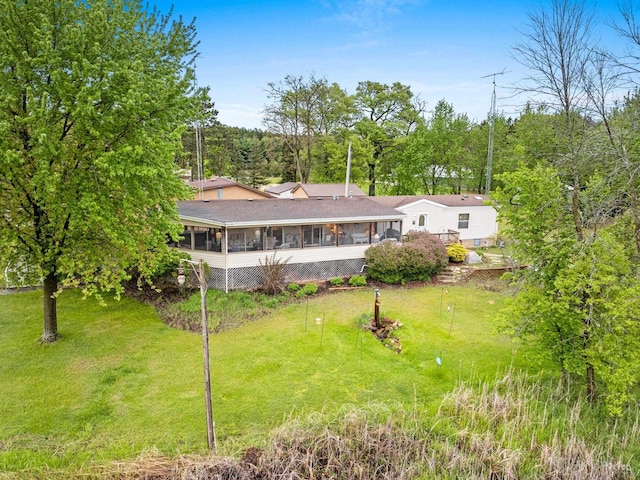 N5101 Lueck Ln, Princeton, WI 54968 - rear view of house featuring a sunroom and a lawn