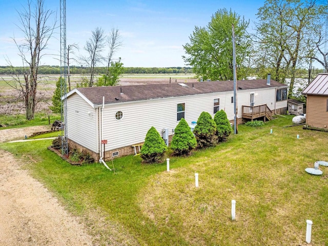 N5101 Lueck Ln, Princeton, WI 54968 - view of home's exterior featuring a lawn, a deck, and roof with shingles