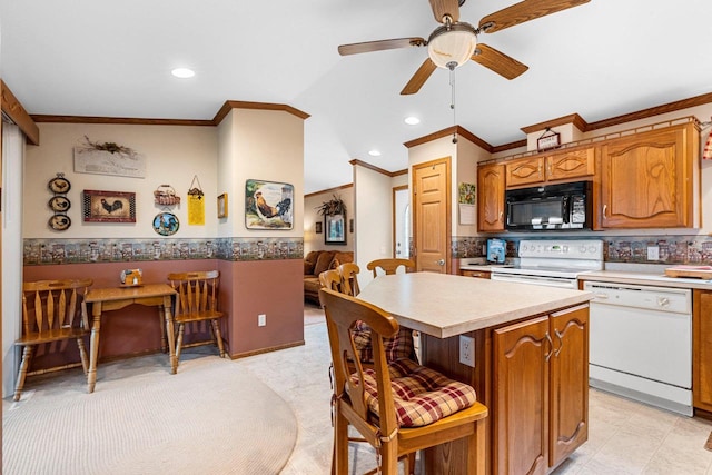N5101 Lueck Ln, Princeton, WI 54968 - kitchen with white appliances, a ceiling fan, ornamental molding, light countertops, and a kitchen island