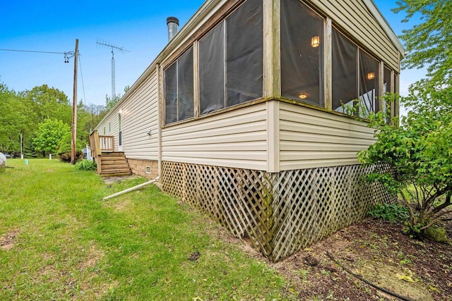 N5101 Lueck Ln, Princeton, WI 54968 - view of side of home with a lawn, crawl space, and a sunroom