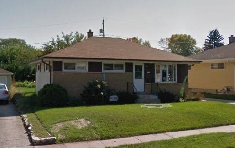 2804 S 64th St, Milwaukee, WI 53219 - view of front of property featuring a front yard and asphalt driveway