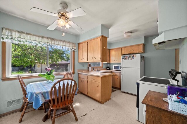 2804 S 64th St, Milwaukee, WI 53219 - kitchen featuring freestanding refrigerator, stainless steel microwave, stove, a sink, and light countertops