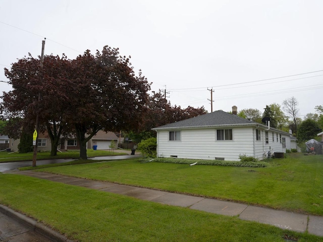 2019 N Mcdonald St, Appleton, WI 54911 - view of side of property with a lawn, a chimney, and central AC unit