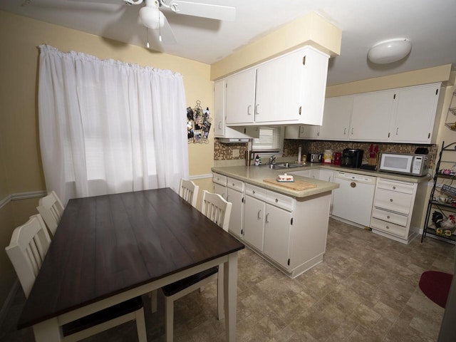 2019 N Mcdonald St, Appleton, WI 54911 - kitchen featuring white appliances, a peninsula, backsplash, a ceiling fan, and a sink