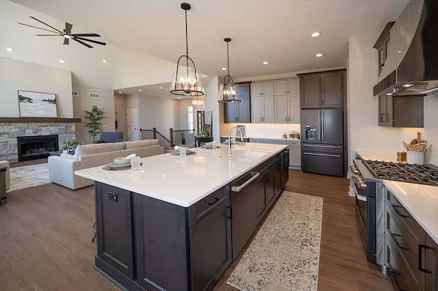 W214N6684 Fairview Dr, Menomonee Falls, WI 53051 - kitchen featuring a sink, premium appliances, wall chimney exhaust hood, dark wood finished floors, and recessed lighting
