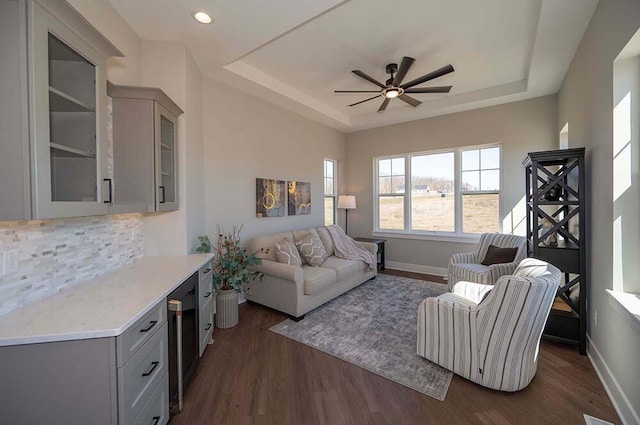 W214N6684 Fairview Dr, Menomonee Falls, WI 53051 - living area with a tray ceiling, a ceiling fan, dark wood-style flooring, baseboards, and recessed lighting