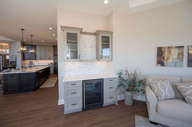 W214N6684 Fairview Dr, Menomonee Falls, WI 53051 - bar with wine cooler, a sink, dark wood finished floors, recessed lighting, and pendant lighting