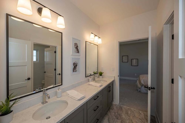W214N6684 Fairview Dr, Menomonee Falls, WI 53051 - ensuite bathroom with double vanity, toilet, and baseboards
