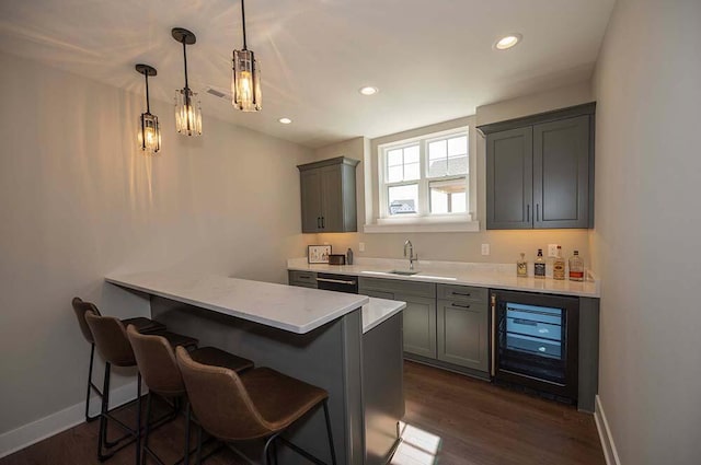 W214N6684 Fairview Dr, Menomonee Falls, WI 53051 - indoor wet bar featuring wine cooler, dark wood finished floors, recessed lighting, baseboards, and decorative light fixtures