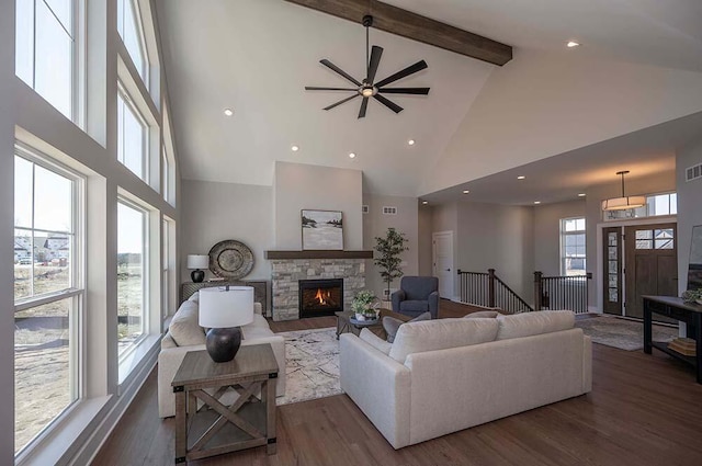 W214N6684 Fairview Dr, Menomonee Falls, WI 53051 - living room featuring high vaulted ceiling, a stone fireplace, beam ceiling, wood finished floors, and a ceiling fan