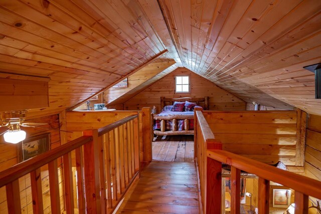 N8378 Timber Trl, New Lisbon, WI 53950 - hall featuring wooden walls, wooden ceiling, vaulted ceiling, hardwood / wood-style floors, and an upstairs landing