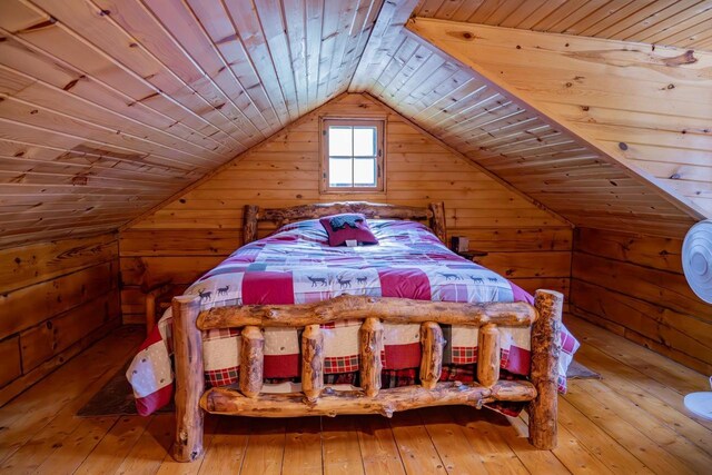 N8378 Timber Trl, New Lisbon, WI 53950 - bedroom featuring wood ceiling, wooden walls, lofted ceiling, and hardwood / wood-style flooring