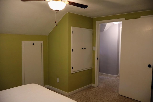 811 Spruce Dr, La Crescent, MN 55947 - unfurnished bedroom with carpet flooring, baseboards, a ceiling fan, and vaulted ceiling