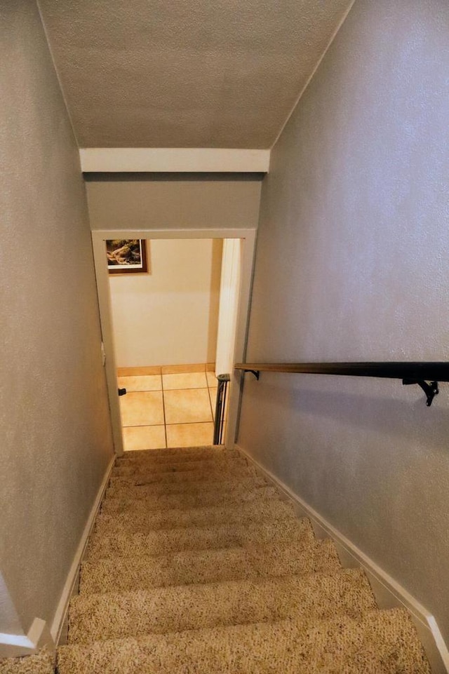811 Spruce Dr, La Crescent, MN 55947 - stairs featuring a textured ceiling and baseboards