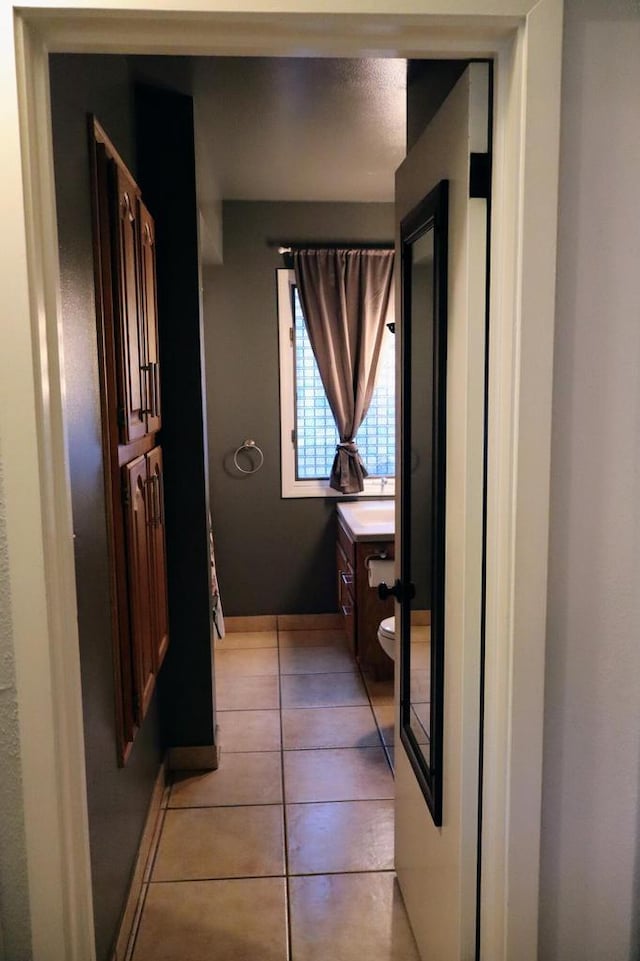 811 Spruce Dr, La Crescent, MN 55947 - bathroom featuring vanity, tile patterned floors, and toilet