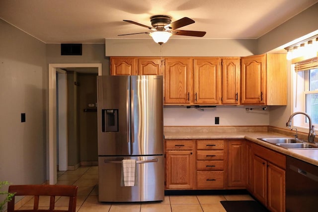 811 Spruce Dr, La Crescent, MN 55947 - kitchen with appliances with stainless steel finishes, a sink, light tile patterned floors, ceiling fan, and light countertops