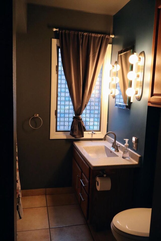 811 Spruce Dr, La Crescent, MN 55947 - bathroom featuring tile patterned floors, toilet, a chandelier, and vanity