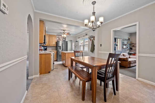 1215 Hastings St, Green Bay, WI 54301 - dining area with arched walkways, ceiling fan, crown molding, a chandelier, and baseboards