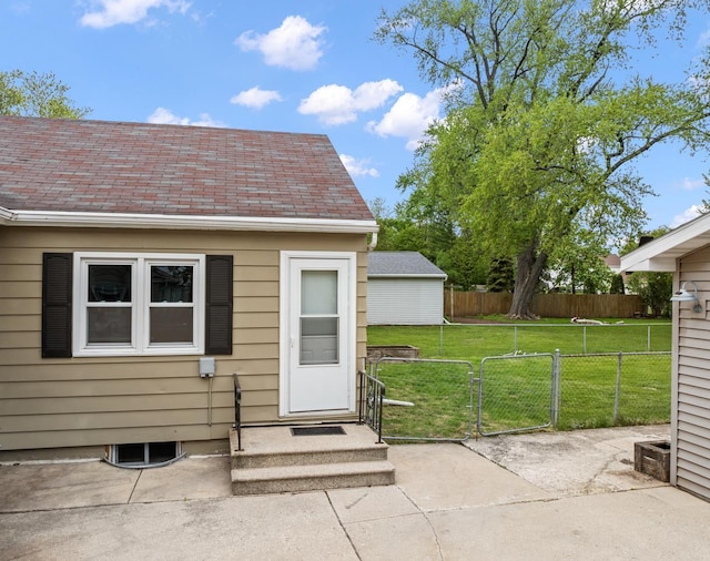 1215 Hastings St, Green Bay, WI 54301 - view of exterior entry with a gate and roof with shingles