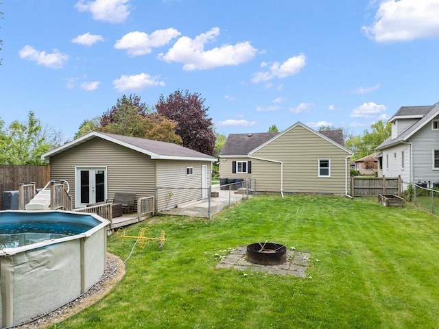 1215 Hastings St, Green Bay, WI 54301 - rear view of property featuring a fire pit and a deck