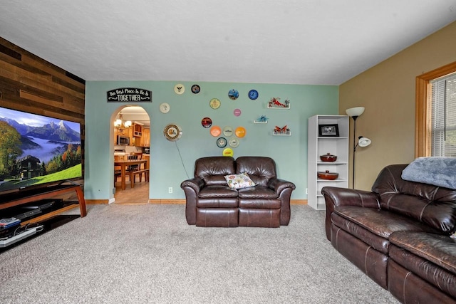 1215 Hastings St, Green Bay, WI 54301 - carpeted living room featuring arched walkways, baseboards, and wood walls