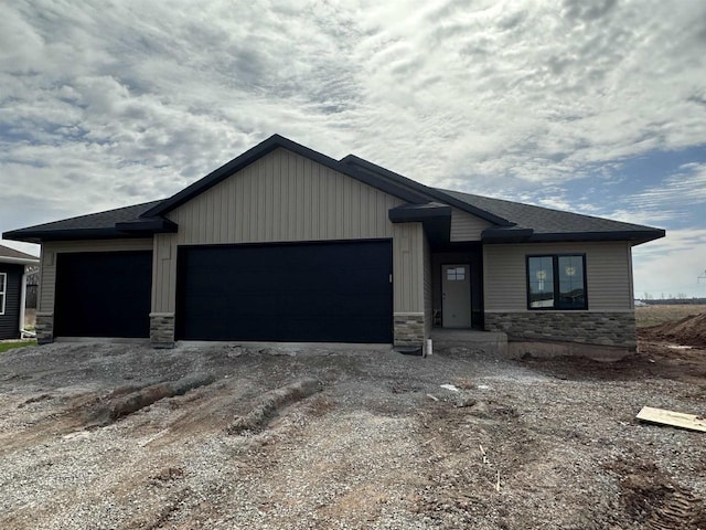 726 Tambour Ct, De Pere, WI 54115 - view of front of house featuring stone siding, an attached garage, and dirt driveway