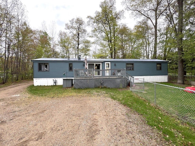 6898 Barbara Dr, Lake Tomahawk, WI 54539 - back of property with a deck and view of scattered trees