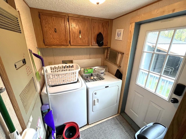 6898 Barbara Dr, Lake Tomahawk, WI 54539 - laundry room with washer and clothes dryer, cabinet space, a textured ceiling, and a heating unit