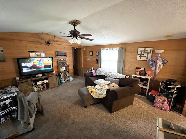 6898 Barbara Dr, Lake Tomahawk, WI 54539 - living room with wood walls, carpet floors, ceiling fan, vaulted ceiling, and a textured ceiling