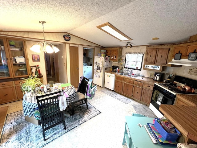 6898 Barbara Dr, Lake Tomahawk, WI 54539 - kitchen with white appliances, a sink, washer / clothes dryer, brown cabinets, and lofted ceiling