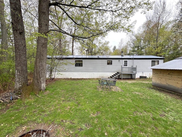 6898 Barbara Dr, Lake Tomahawk, WI 54539 - back of property featuring a yard