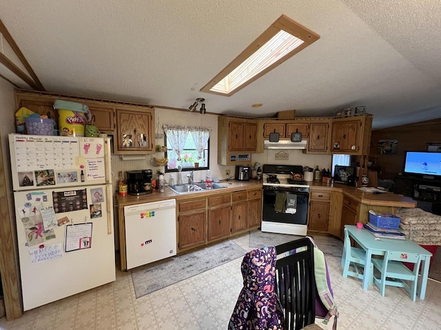6898 Barbara Dr, Lake Tomahawk, WI 54539 - kitchen with white appliances, under cabinet range hood, light floors, a sink, and a textured ceiling